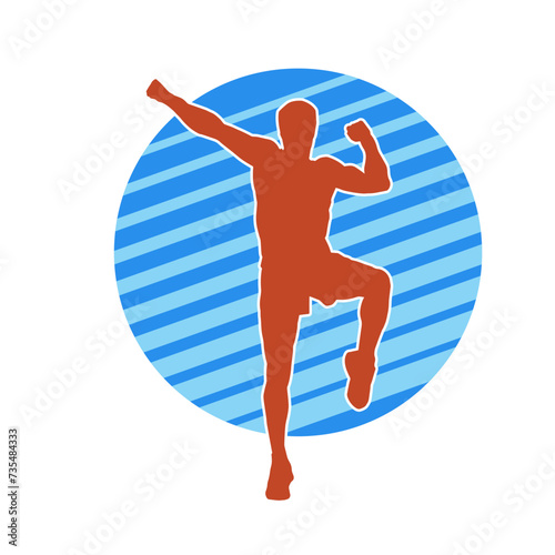 Silhouette of a sporty male in action pose at the gym. Silhouette of a slim man in aerobics workout pose.