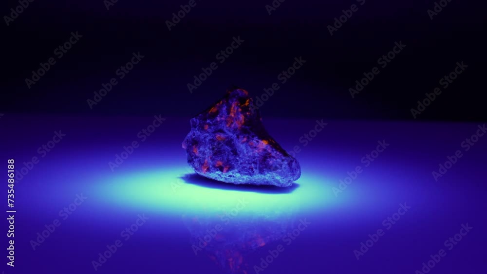 natural yoopelite gem in ultraviolet light on the background natural yoopelite gem in ultraviolet light on the background
