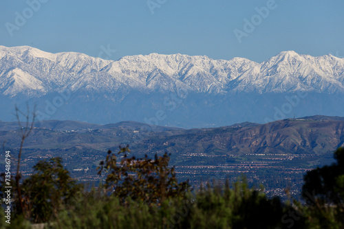 green valley with snow capped mountains in the distance