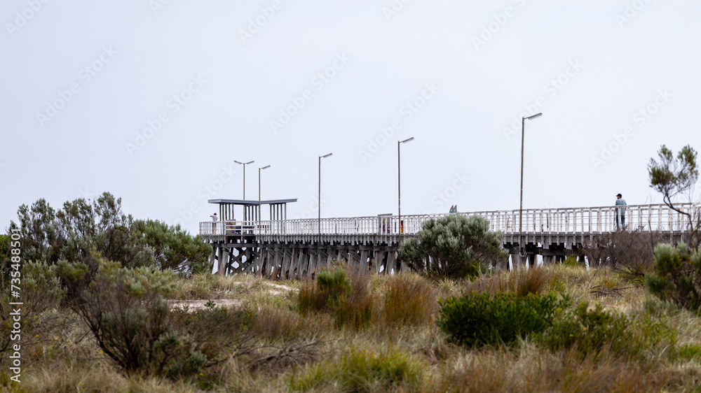 Largs North Jetty with selective focus over the conservation dunes in South Australia on 18th September 2023