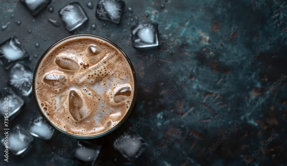 Frothy iced coffee with creamy milk and ice cubes for refreshing summer drink