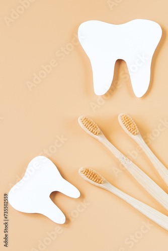 Eco-friendly wooden toothbrushes on trendy beige background. Dental care concept. Happy dentist day.