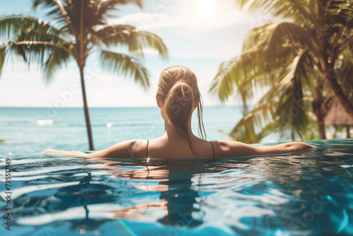 Sensual young woman in swimming pool. Woman on tropical vacation paradise on sea. Summer sea background. Summer vacation travel holiday background concept © Enrique
