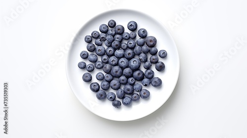 Blueberries, on a white round plate, on a white background, top view