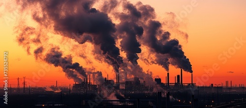 Aerial view of a massive industrial plant emitting heavy smoke into the atmosphere