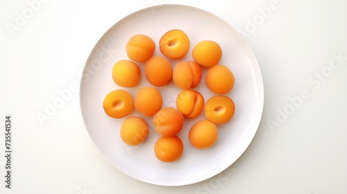 Apricot placed on a circular white plate against a white backdrop, viewed from above