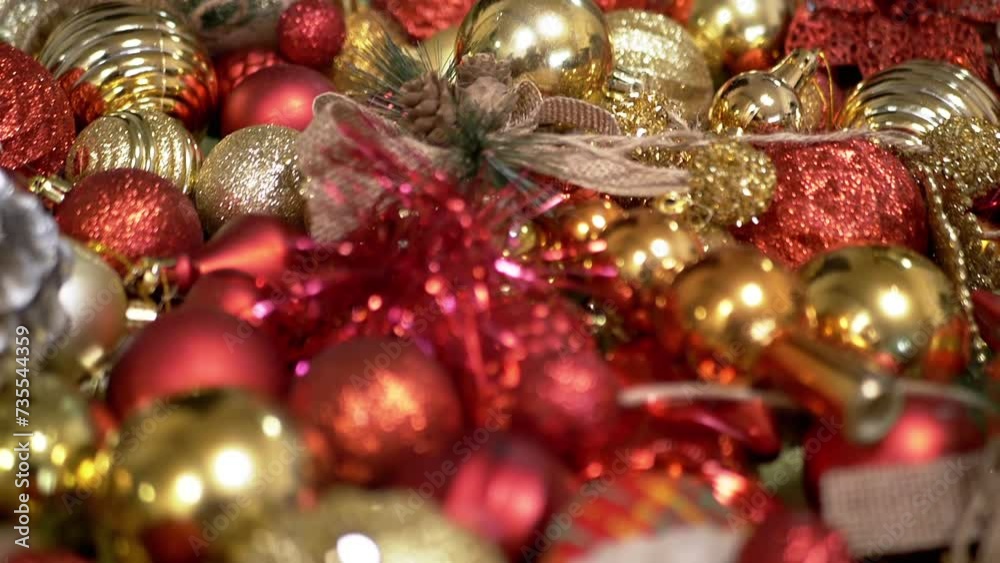 Gray Scottish Cat Sits on the Floor in the Background Christmas Tree Decorations. Close up. Funny cat with green eyes on shiny colorful Christmas balls, toys, garlands. Room. Merry Christmas, 2025.