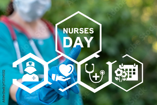 Nurse using virtual touch screen presses inscription: NURSES DAY. Concept of international happy nurse day greeting. photo