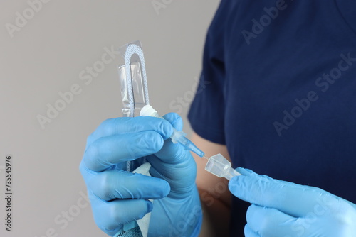 Health care professional wearing gloves manipulating the peripheral catheter pack  photo