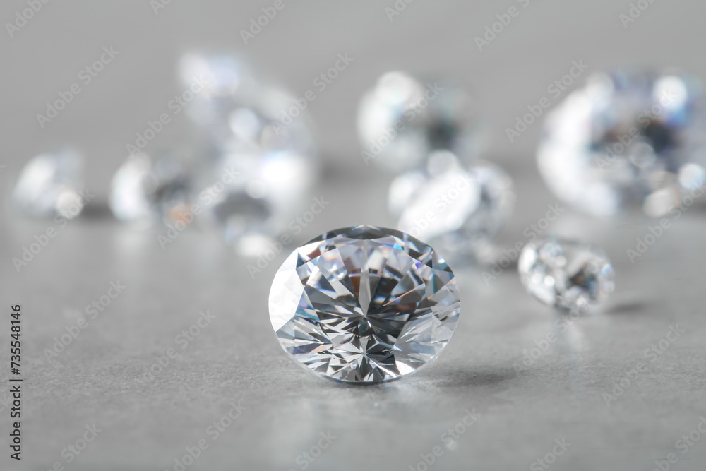 Beautiful shiny diamond on gray table, space for text Beautiful shiny diamond on gray table, space for text