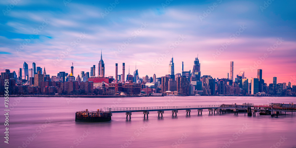 Panoramic Sunset Manhattan Skyline, New York City Skyscrapers, and serene waterfront landscape over the East River, a view from the Grand Ferry Park in Williamsburg, Brooklyn, New york, USA