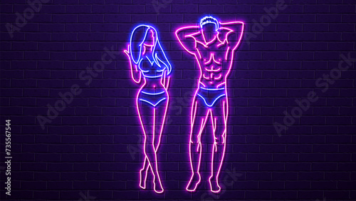 Neon sexy woman and man with a beautiful pumped-up body in blue and pink on a brick wall background.