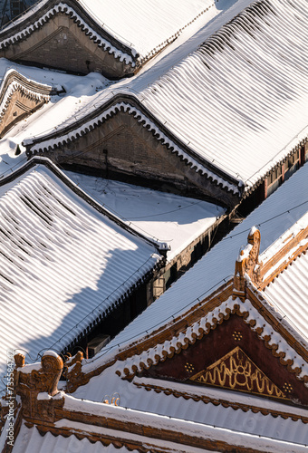 Rooftop of Chinese traditional building covering with snow. Beijing, China