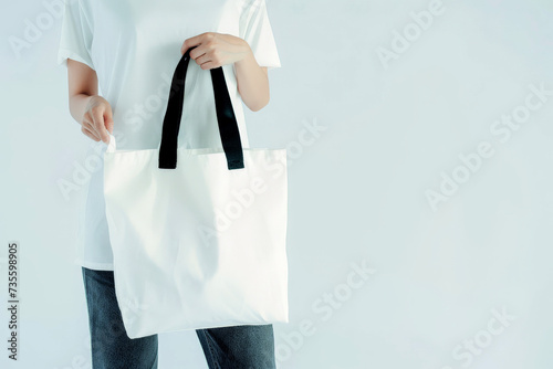 woman Hand holding a White Polyester square tote bag for mockup . AI generated image