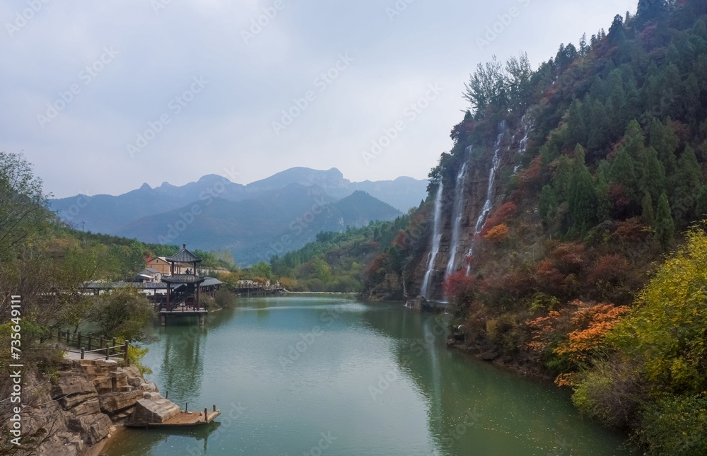 Panoramic view of the beautiful lake, waterfall, canyon, and pavilion in autumn. China, Shandong. 