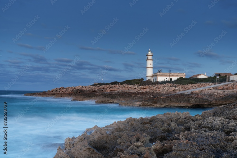 long exposure view of the Cap de ses Salines Lighthouse on Mallorca just before sunrise