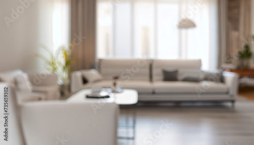 Blurred view of living room interior with white sofa, armchair and coffee table © Uuganbayar