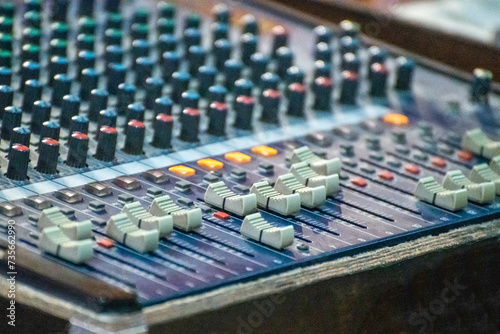 Sound engineer using mixing console to produce a sound track.