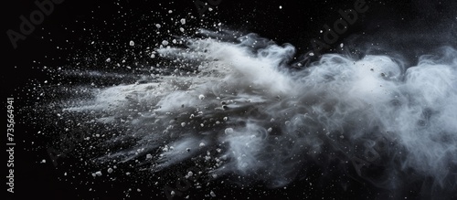 Ethereal white powder explosion on dramatic black background for creative, artistic, and impactful design elements
