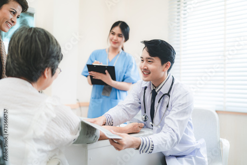 Professional male doctor in white medical uniform talk discuss results or symptoms with female patient  man GP or physician consult client give recommendation at meeting in hospital  health insurance