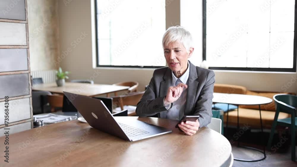 Mature woman working from the cafe Mature woman working from the cafe
