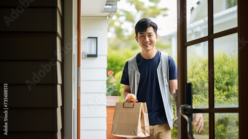 Young man delivering food to customer at doorway