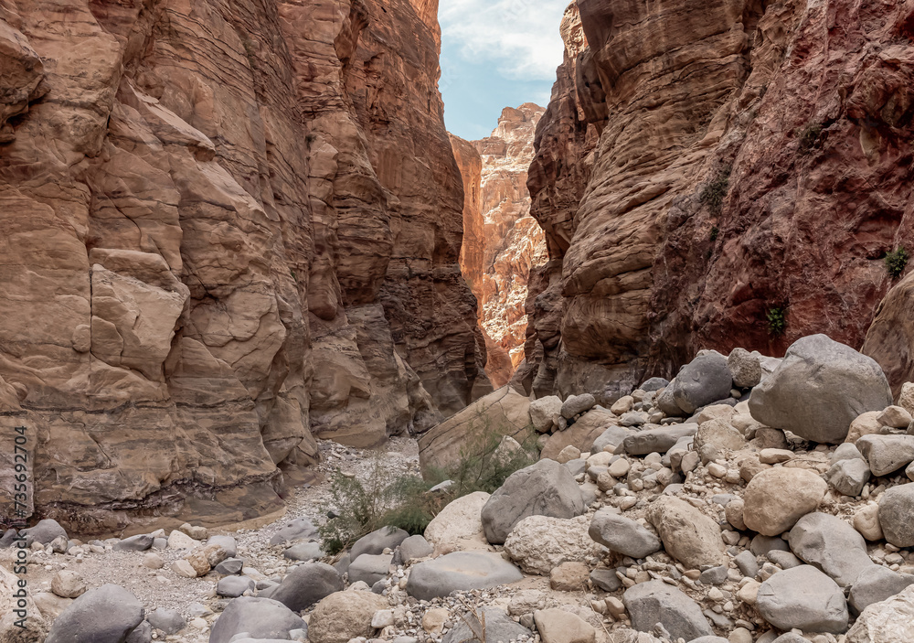 The indescribable beauty of high mountains on the sides of the gorge of the tourist route of the gorge Wadi Al Ghuwayr or An Nakhil and the wadi Al Dathneh near Amman in Jordan