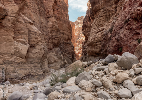 The indescribable beauty of high mountains on the sides of the gorge of the tourist route of the gorge Wadi Al Ghuwayr or An Nakhil and the wadi Al Dathneh near Amman in Jordan