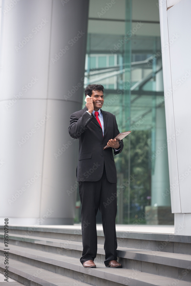 Indian business man talking on his Smart phone.