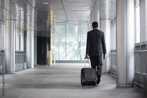 Back view of an Indian businessman walking.