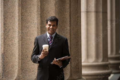 Indian Lawyer or business man outside a colonial building.