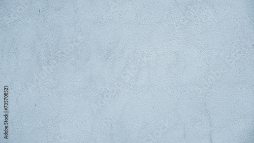Abstract wide angle light blue stucco background.
