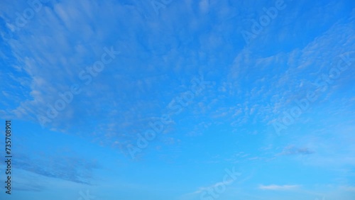 4K : Blue sky time-lapse - A breathtaking dance of clouds across a brilliant blue sky, in seconds. Sunlit sky and Wide-open heavens concept. Autumn background. Time-lapse.
 photo