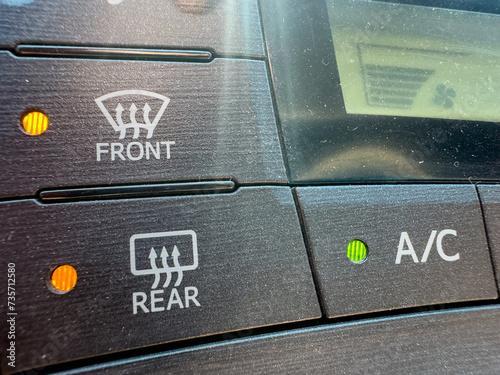 Front and rear defrost button closeup