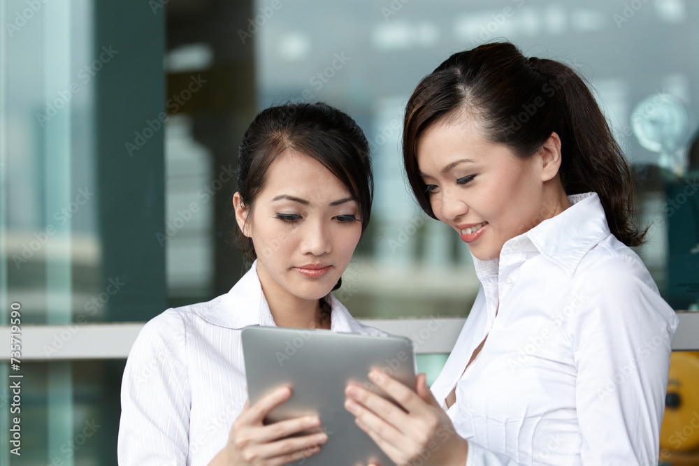 Asian Business woman using a Touch-Pad PC