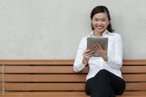 Asian Business woman using a Touch-Pad PC photo