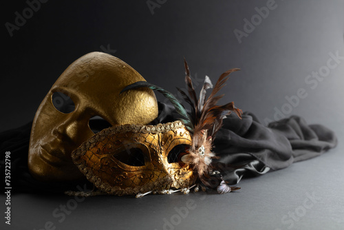 Golden Venetian carnival masks on a black background.