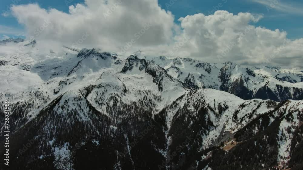 Aerial view of snow mountain range landscape with clouds. Alps mountains, Austria, 4k