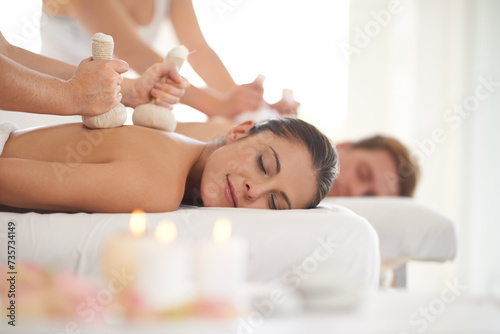 Massage, herbs and couple relax in spa with treatment on body for wellness on holiday or vacation in Thailand. Beauty, care and people together in hotel or resort for healthy Valuka Sweda bag on back