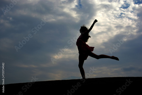 Young girl dancing on the hill