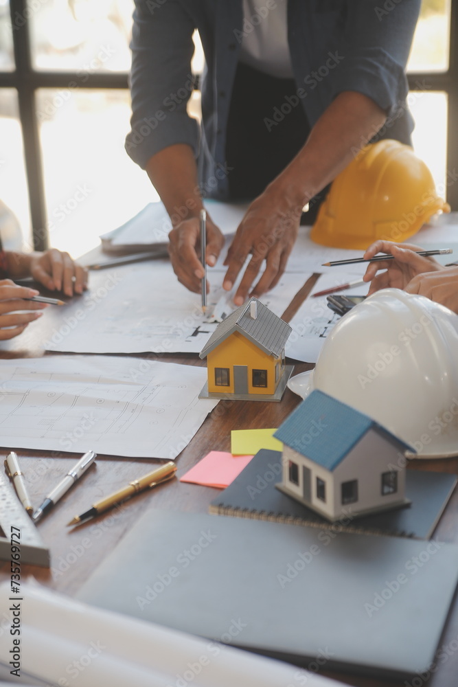 A team of construction engineers talks to managers and construction workers at the construction site. Quality inspection, work plan, home and industrial building design project A team of construction engineers talks to managers and construction workers at the construction site. Quality inspection, work plan, home and industrial building design project