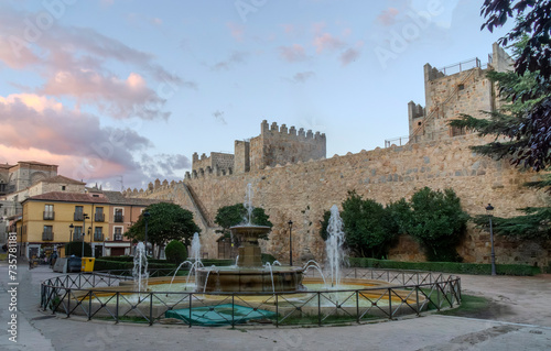 Public fountain in the Adolfo Suarez Square in the city of Avila with the walls in the background. Castile and Leon, Spain. photo