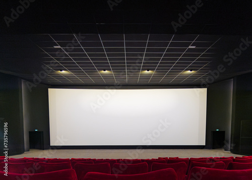 Modern Movie Theater Interior with Red Seats and Blank Screen
