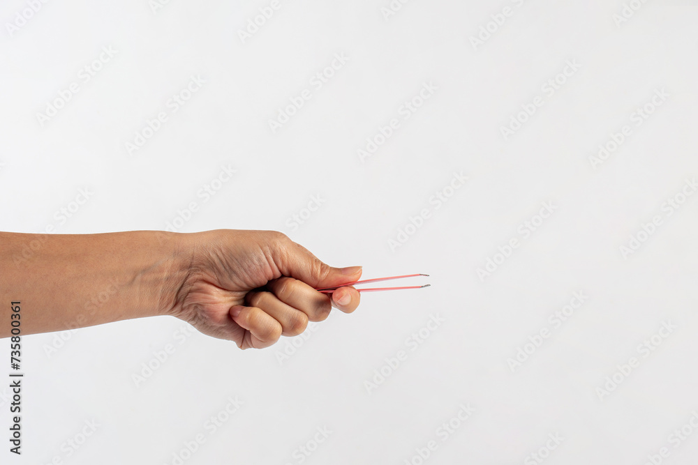 Pink hair tweezers in hand isolated on white background Pink hair tweezers in hand isolated on white background