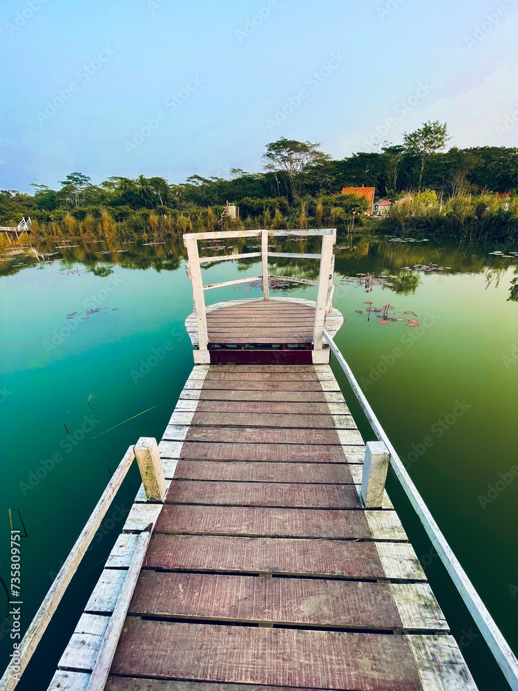 Naklejka premium wooden bridge over the lake
