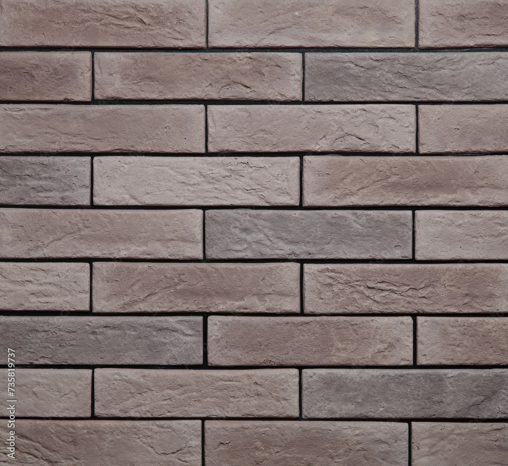 Obraz premium Stone cladding wall made of striped stacked slabs of brown rocks. Panels for exterior. Background and texture.