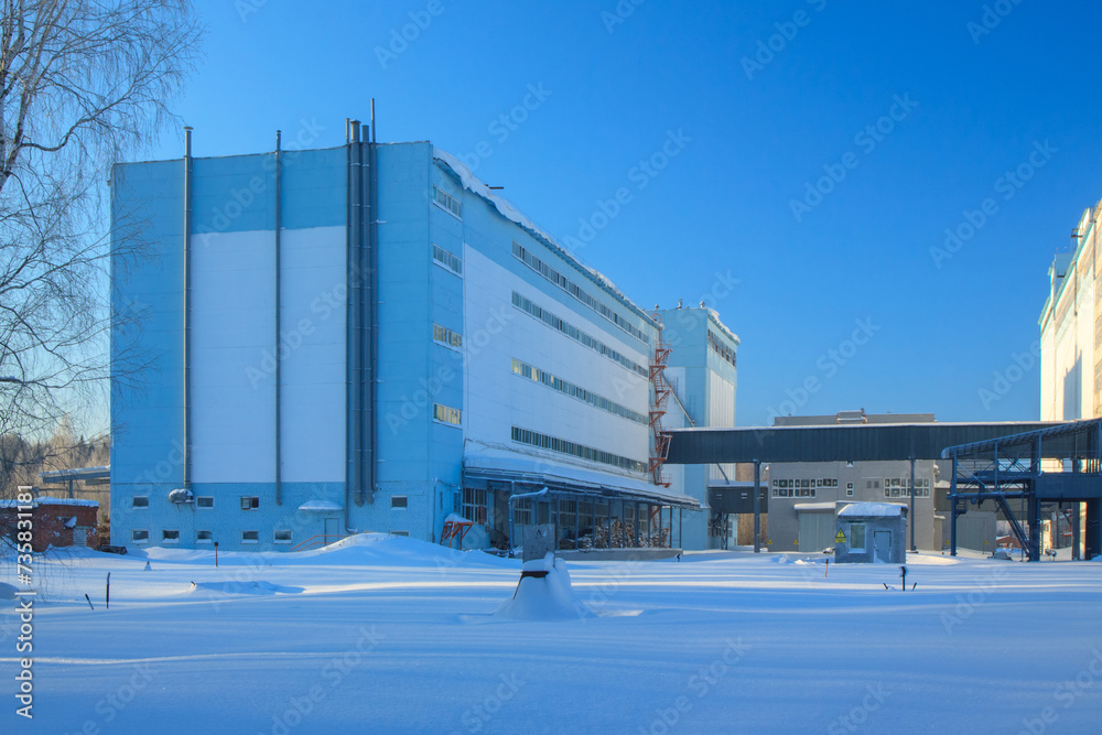 Feed mill, industrial buildings in sunny winter day, nobody. Feed mill, industrial buildings in sunny winter day, nobody.