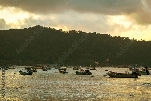 Terengganu, Malaysia - March 16, 2023 Colourful boats  near the floating jetty in Perhentian Island in the morning.