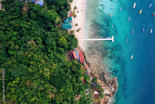 Top view or aerial view of fisherman village with white beach and boats in summer of tropical island named Perhentian Kecil photo