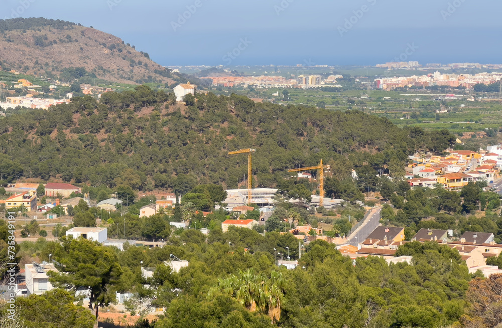 Fototapeta premium Villa in mountains. Mountains landscape with houses on hill. Towhouse and Home on hills. House in mountains. Rural landscape with hills. Houses on Mountain with nature scenery in Gilet Town in Spain.